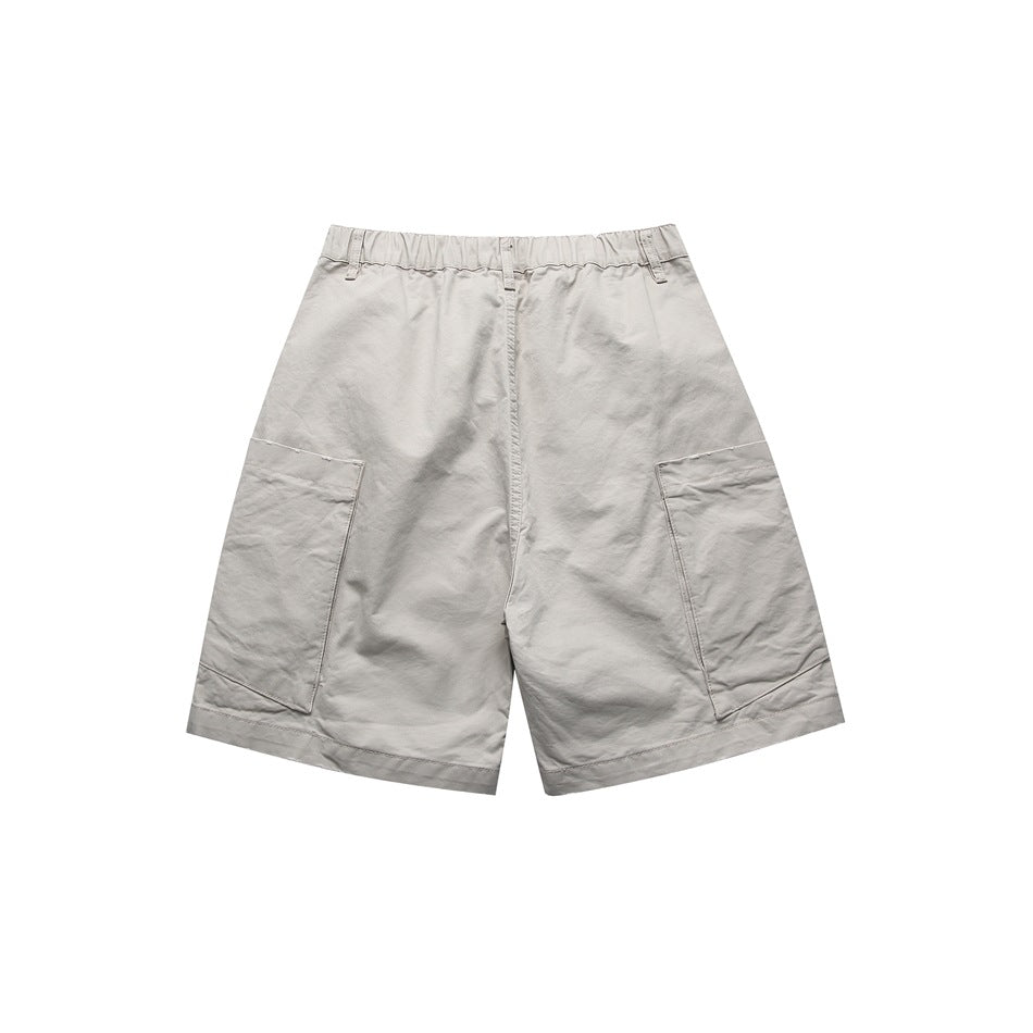 Back view of light gray utility shorts with an elasticized waistband and large side pockets.