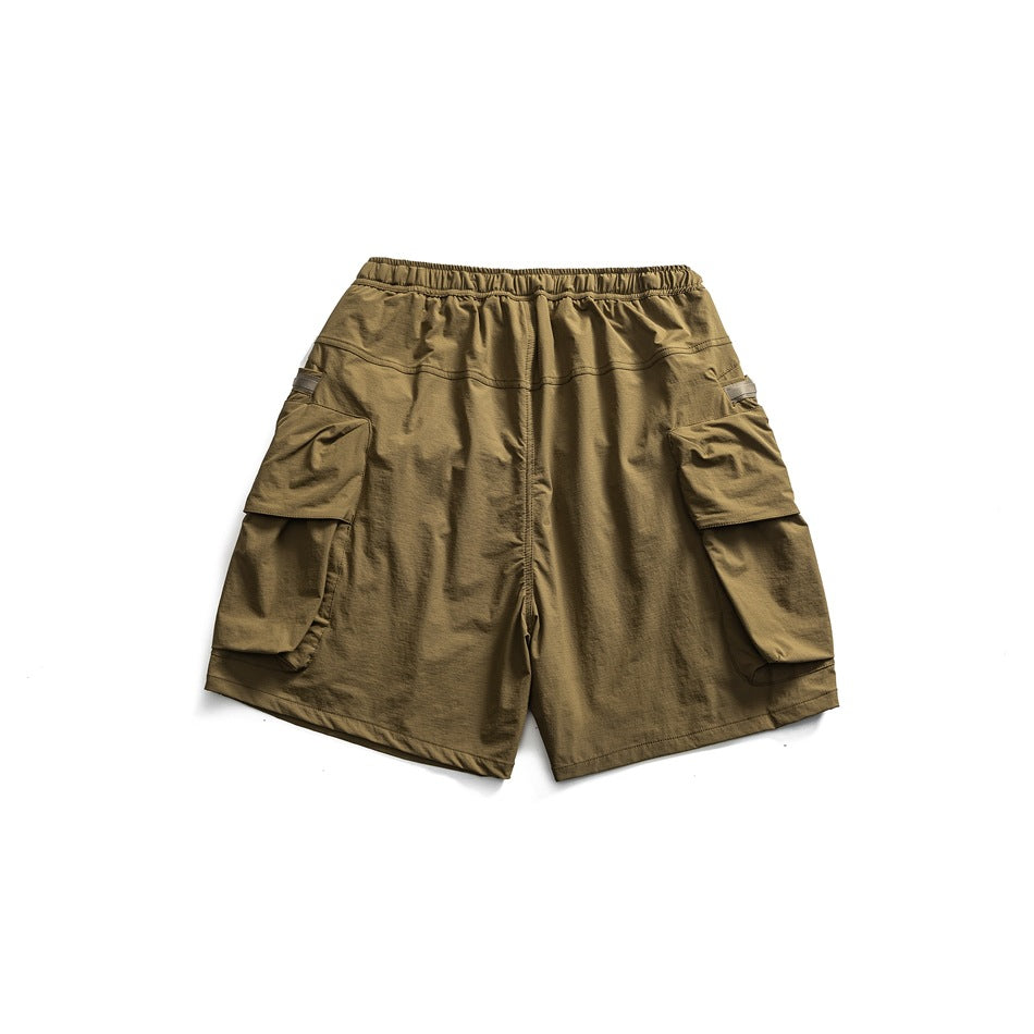Olive-brown cargo shorts, back view, with an elastic waistband and large flap pockets on both sides.