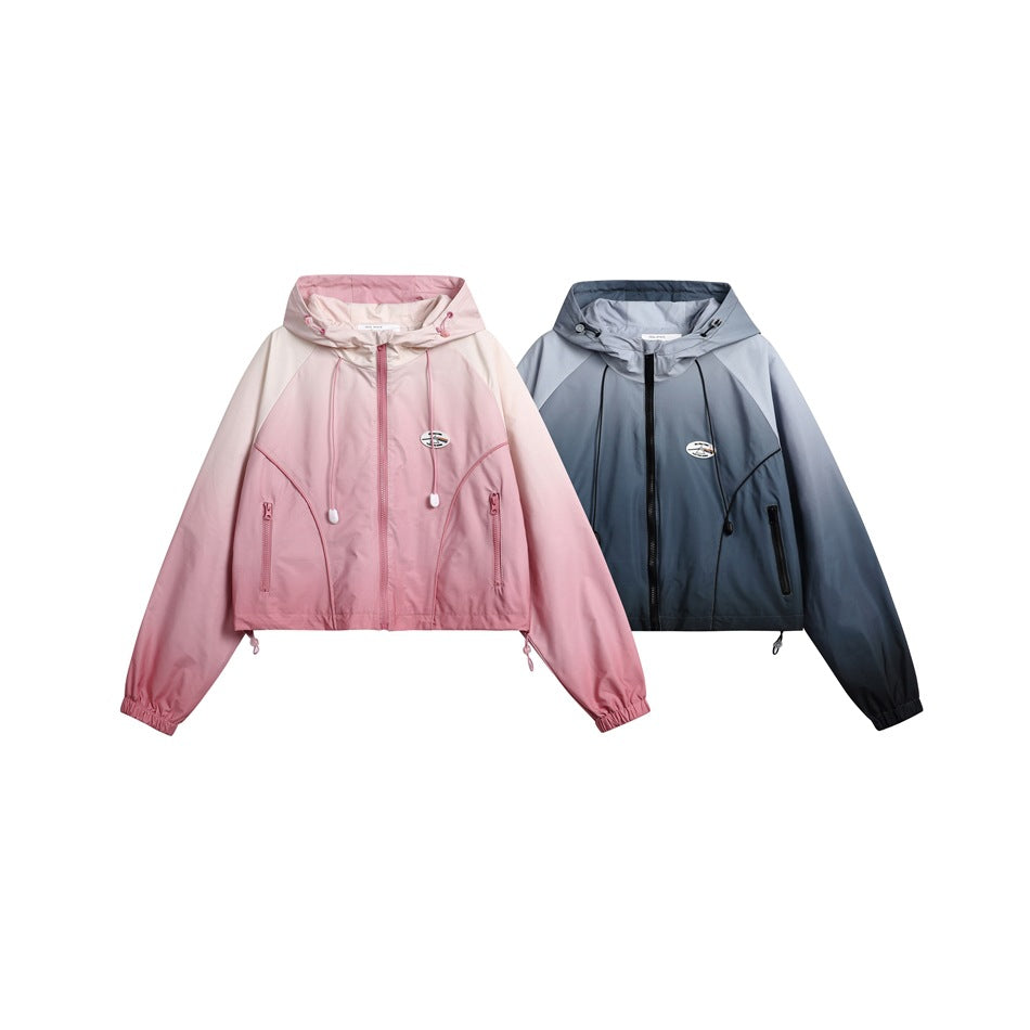 Two cropped hooded zip jackets displayed side by side in pink and blue-gray.
