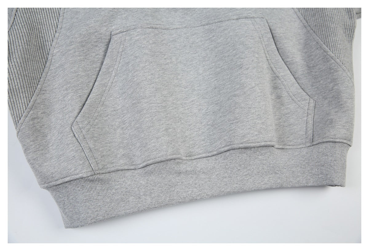 Close-up of the sweatshirt’s front kangaroo pocket and ribbed hem.
