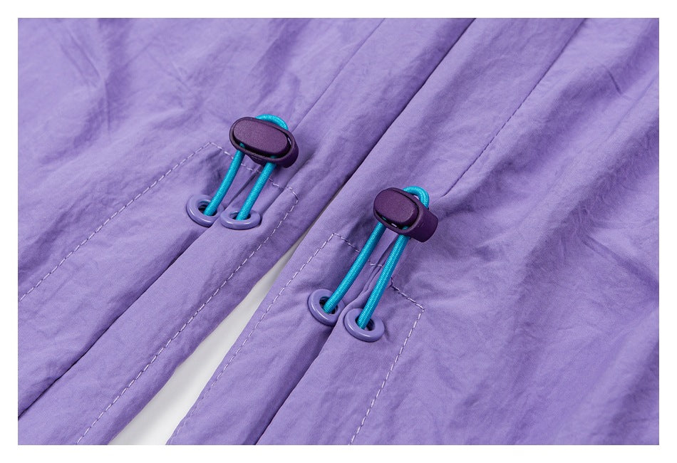 Close-up of lavender pants with turquoise elastic cords threaded through purple eyelets and toggles.
