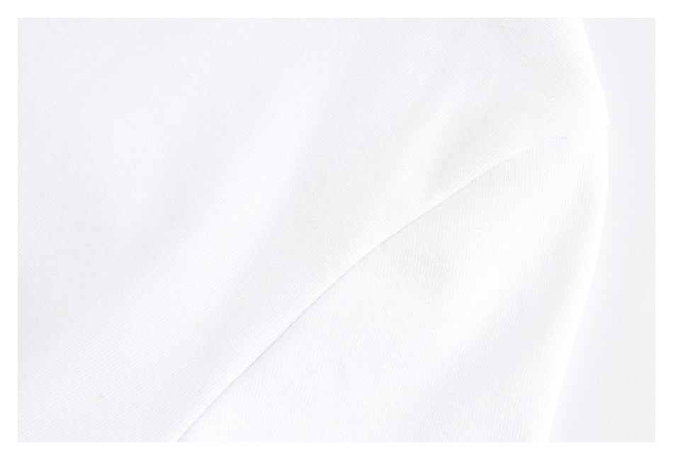 Close-up of a white garment showing a curved seam between fabric panels.