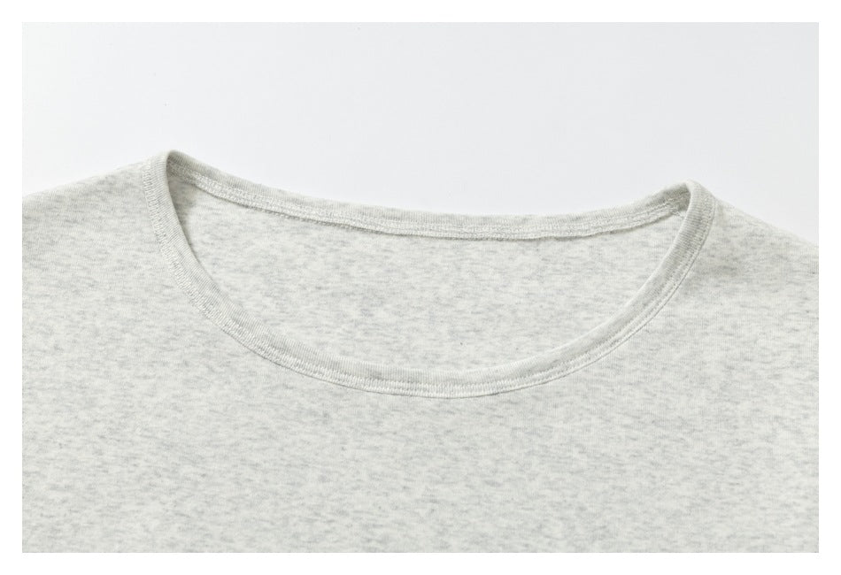 Close-up of the rounded neckline and pale heather-gray fabric of a T-shirt.