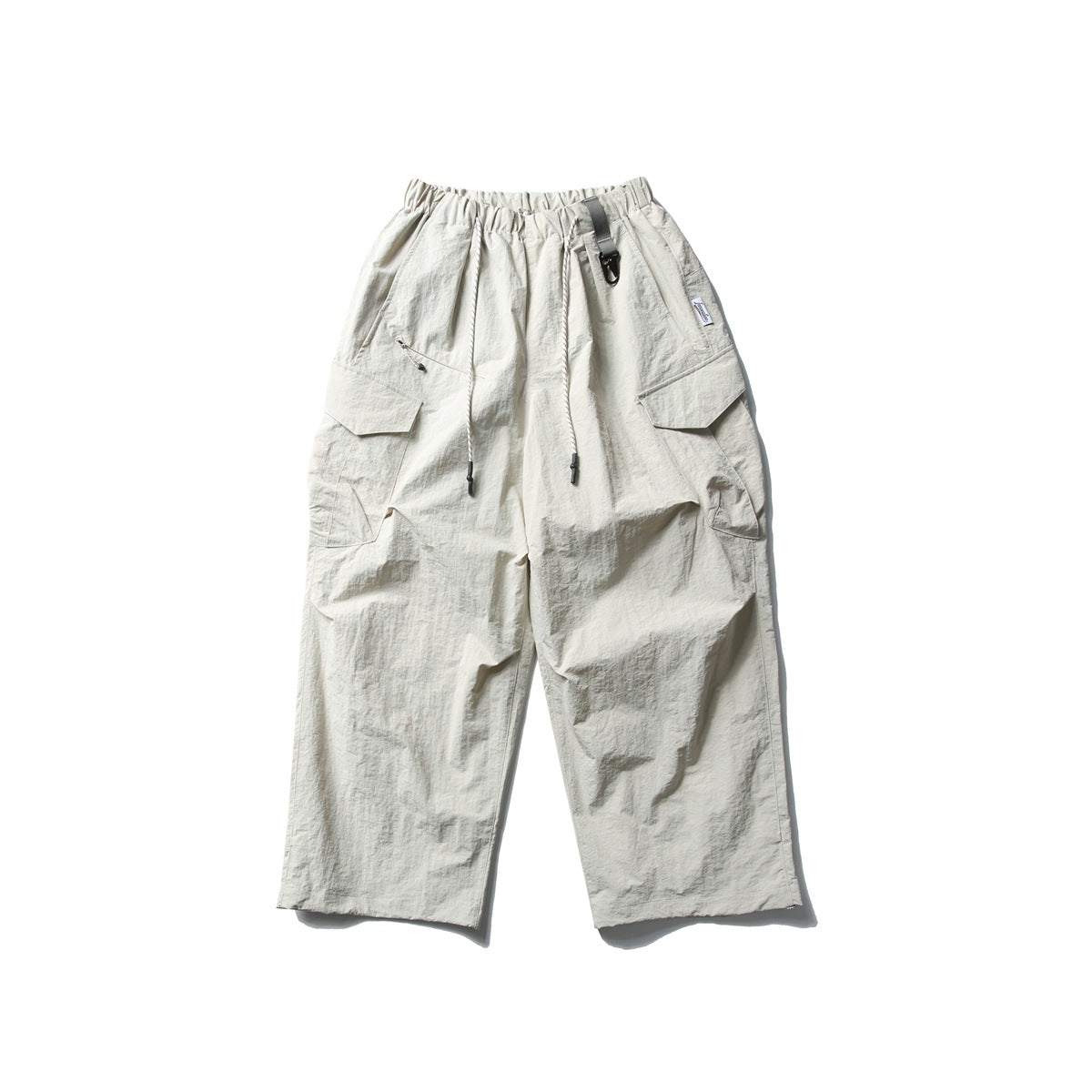 Front view of ivory wide-leg cargo pants with an elastic drawstring waist and large flap pockets.