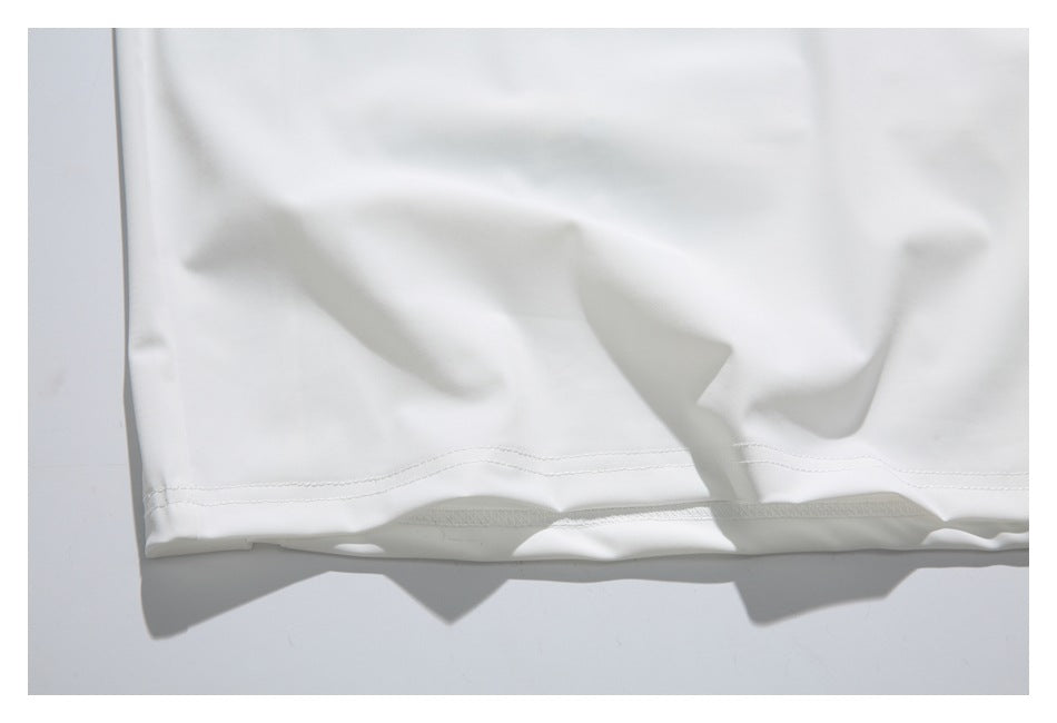 Close-up of the stitched bottom hem of a white shirt.