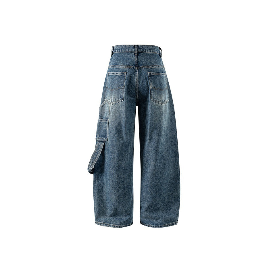 Back view of washed blue wide-leg jeans showing back patch pockets and a side utility pocket with strap loop