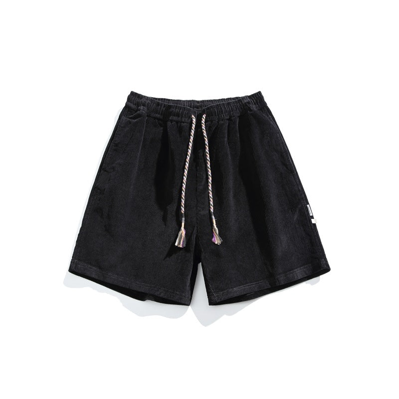 Black corduroy shorts with elastic waist and braided drawcord with tassels, front flat lay