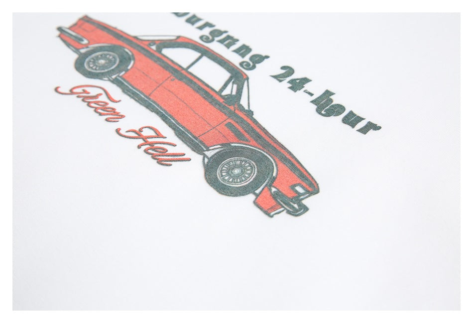 Angled close-up of a red vintage car graphic and English lettering on a white T-shirt.