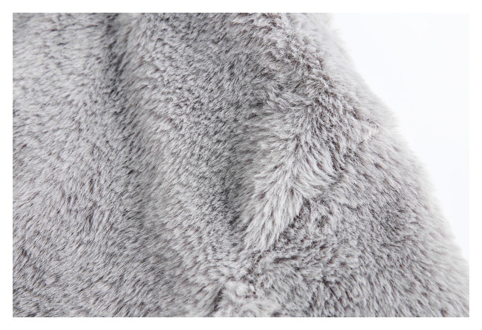 Close-up of gray faux-fur fabric and a curved seam.