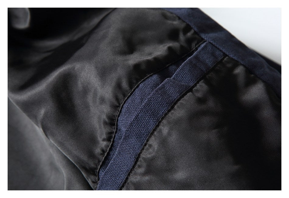 Close-up of the garment's black inner lining and navy stitched seam trim.