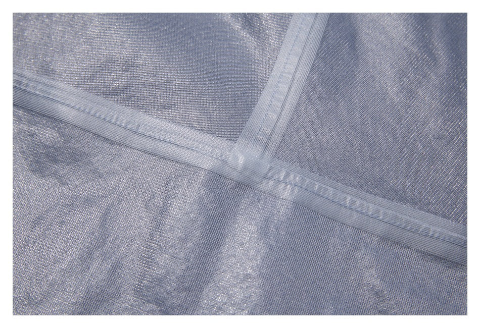 Close-up of silver-gray woven fabric showing intersecting stitched seams.