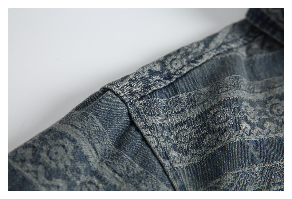 Close-up of a seam and patterned bands on blue denim fabric.