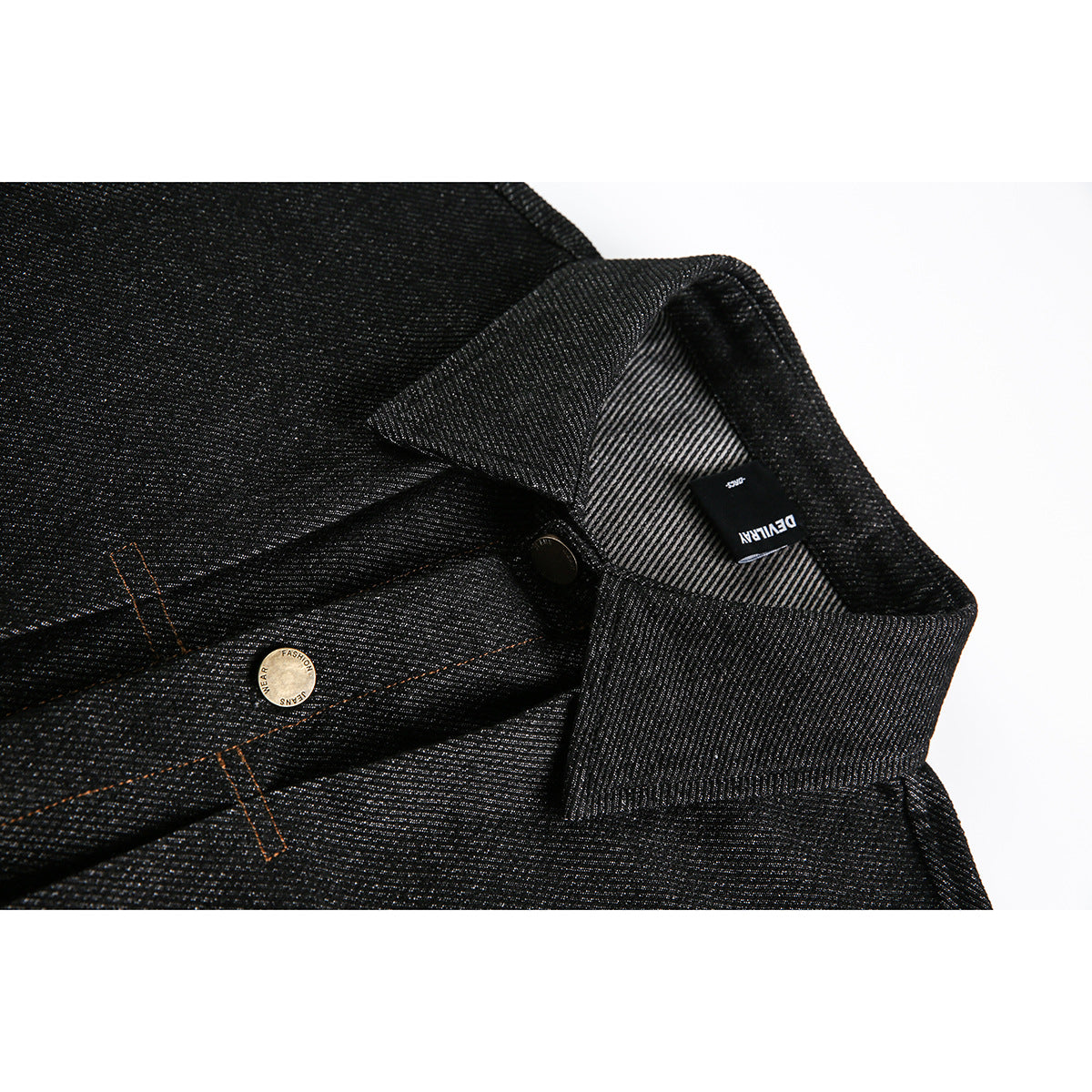 Close-up of a black textured jacket collar, inner label, and brass-tone buttons with orange stitching.