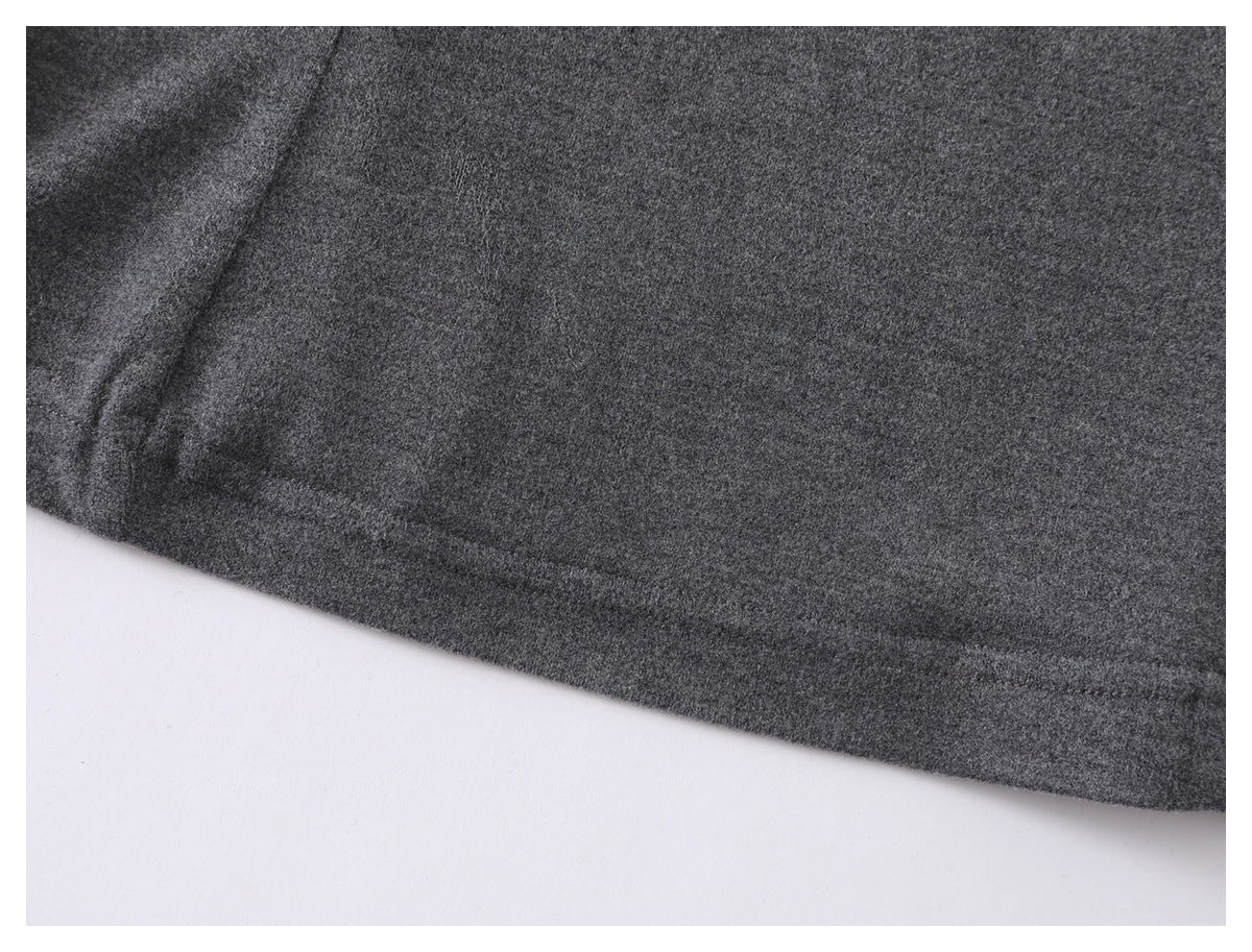 Close-up of a charcoal gray garment hem with a stitched edge.