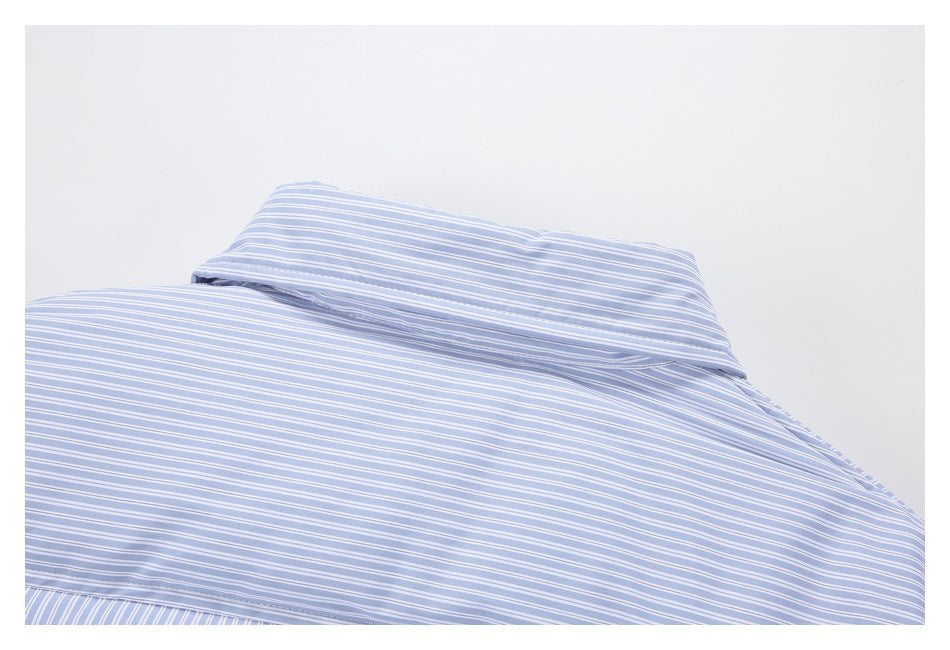 Close-up of light blue and white striped fabric, with a folded, stitched edge near the top.