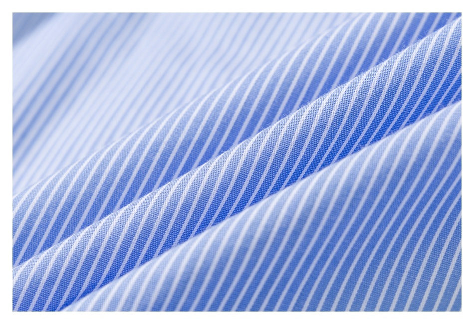 Macro view of blue-and-white striped shirt fabric folded to show its texture.