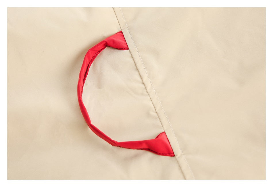 Close-up of a beige garment seam with a red fabric loop detail.
