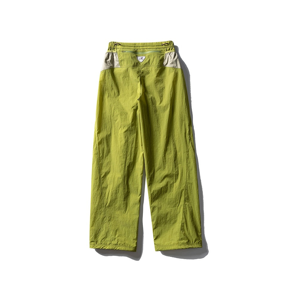 Yellow-green wide-leg pants with beige back panels and a zip pocket at the waist, flat lay back view