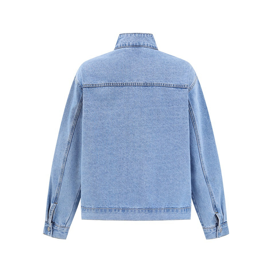 Back view of a light blue denim jacket with a stand collar, long sleeves, and a horizontal upper-back seam.