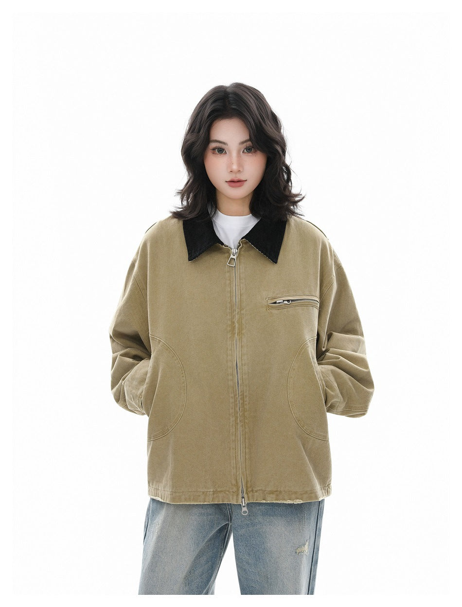 Woman wearing a khaki zip-front jacket with black collar over a white tee and light blue jeans, front view