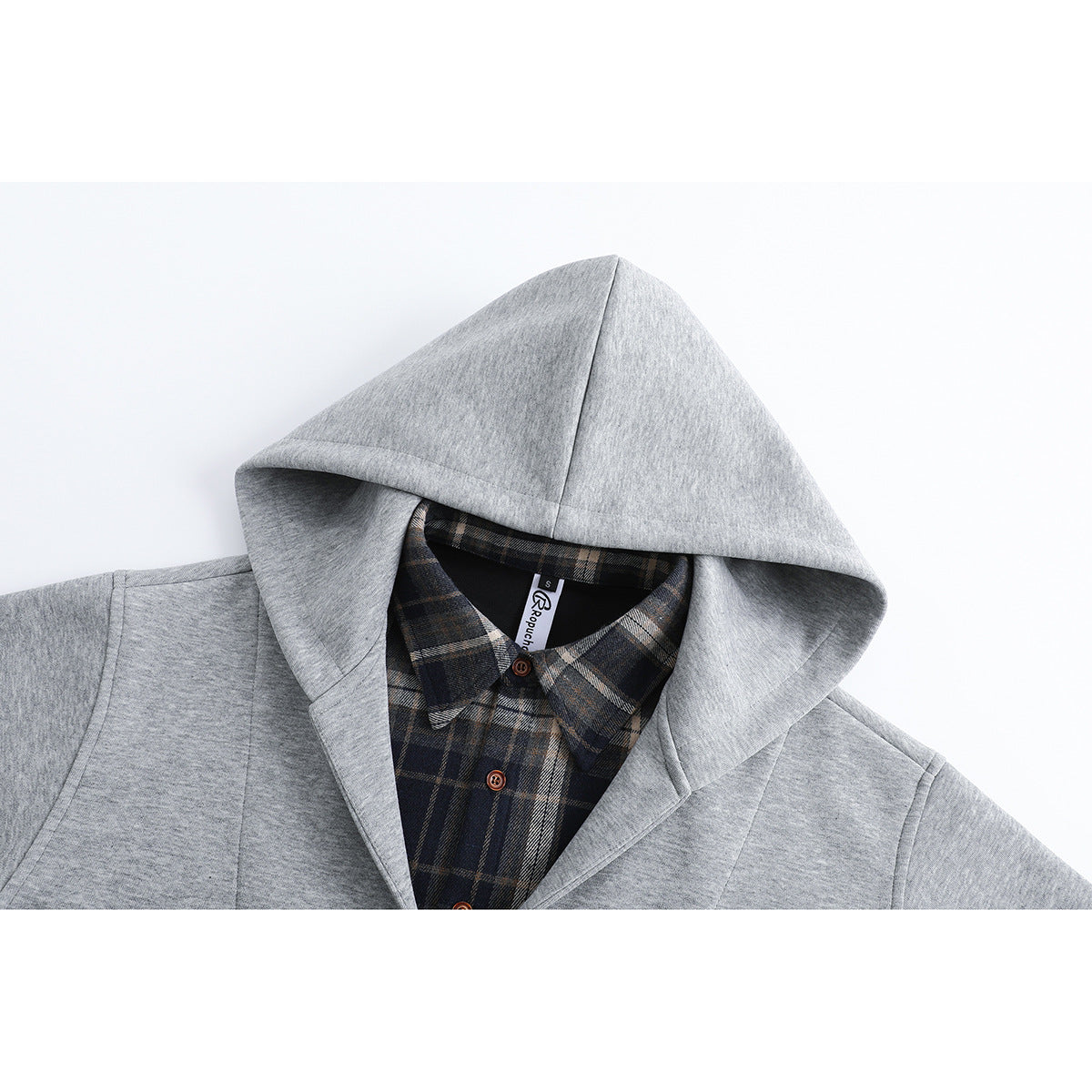 Close-up of a light gray hoodie's hood and neckline, showing a dark plaid button-up shirt layered underneath.