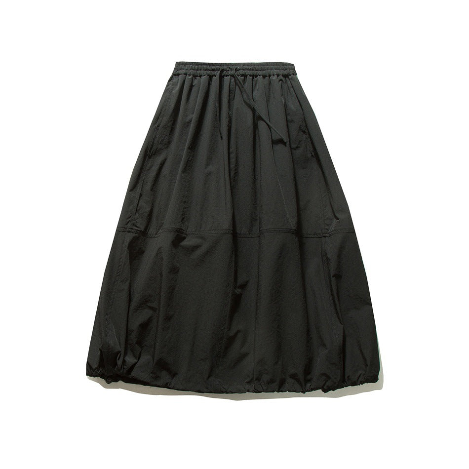 Black long skirt flat lay front view with elastic drawstring waist, seamed lower panel and gathered hem