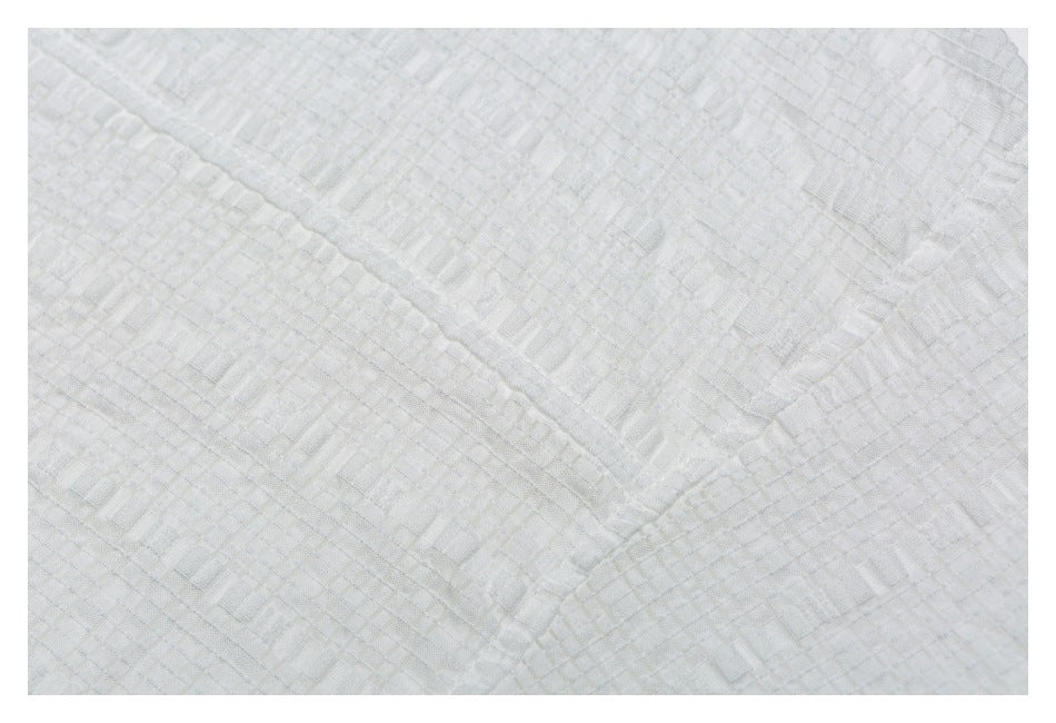 Close-up showing the white shirt's subtle raised geometric fabric texture.