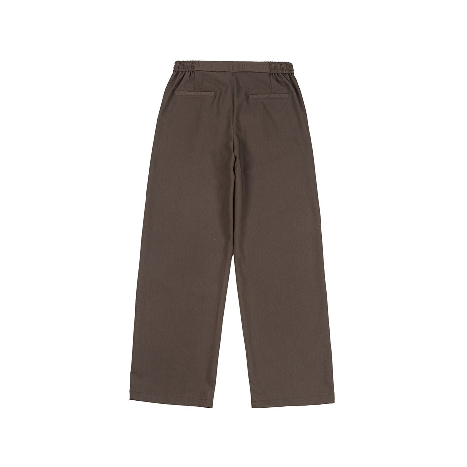 Brown wide-leg trousers flat lay, back view with elastic waistband and two welt-style back pockets
