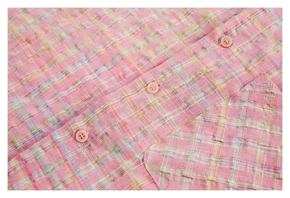 Close-up of the pink plaid shirt's button placket and chest pocket.