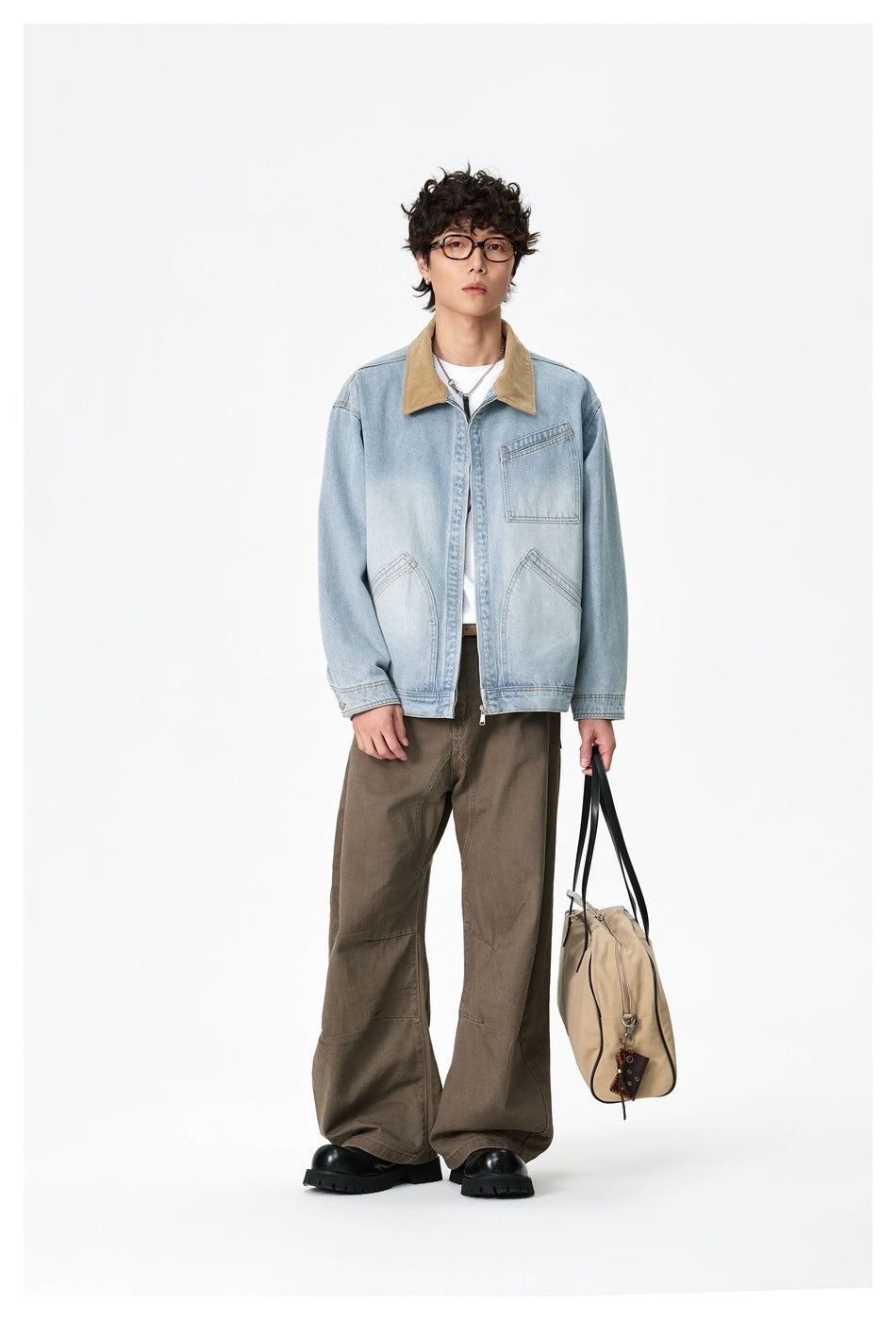 Full-length model wearing a light-wash denim jacket with a tan collar, chest pocket and zip front.