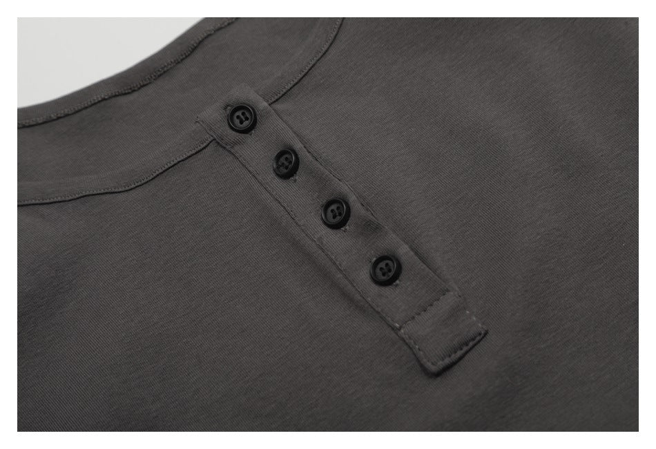 Close-up of the charcoal tank's four-button placket and neckline stitching.