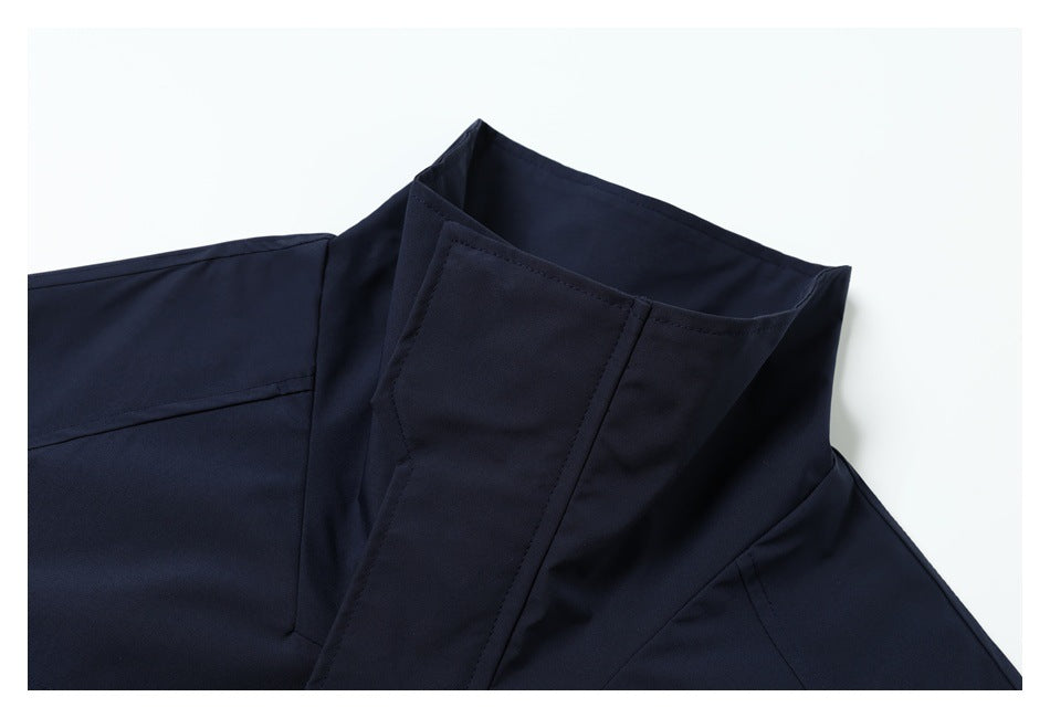Close-up of the raised collar and stitched panels of a dark navy jacket.