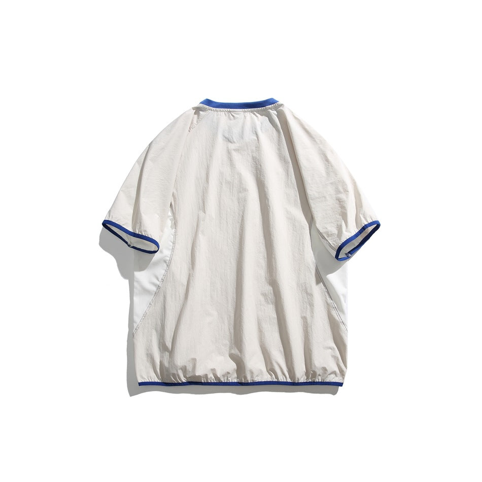 Back view of a white short-sleeve shirt with blue trim at the collar, cuffs, and hem, laid flat.