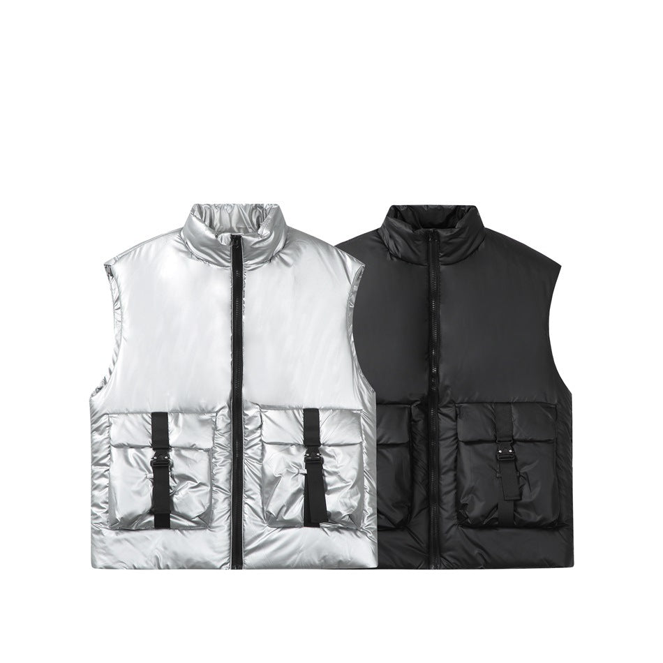 Silver and black sleeveless padded vests shown side by side, each with a high collar, front zip, and large buckle-detail