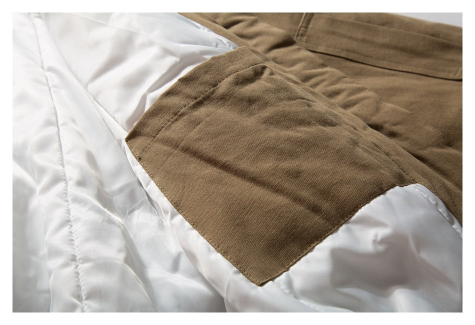 Close-up of a tan-brown garment panel over white quilted lining.