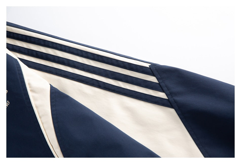 Close-up of cream-and-navy stripes and color-block panels along the jacket sleeve.