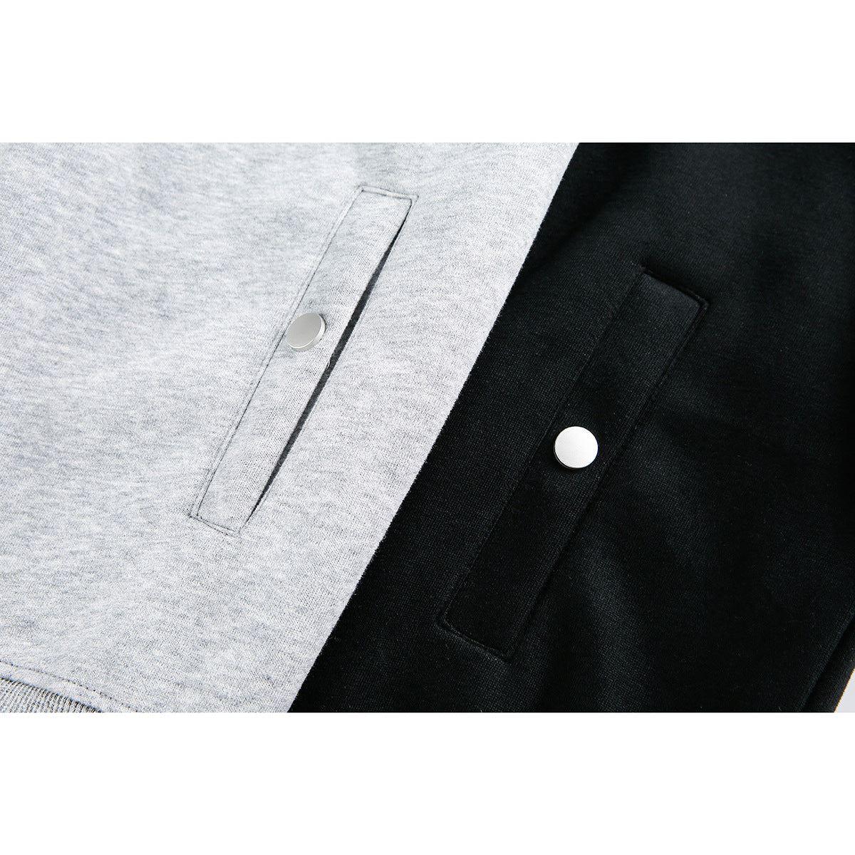 Close-up of gray and black hoodie pockets, each with a round snap closure.