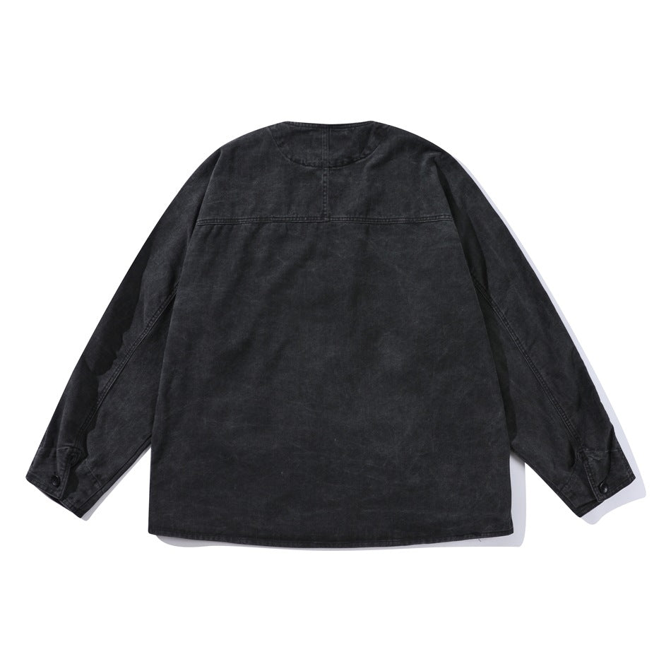 Black washed collarless jacket back view with yoke seam and buttoned cuffs, flat lay