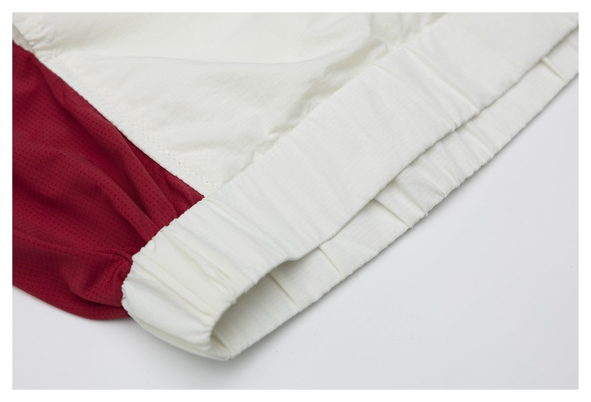 Close-up of the white garment's elasticized edge beside a burgundy mesh-like inner panel.