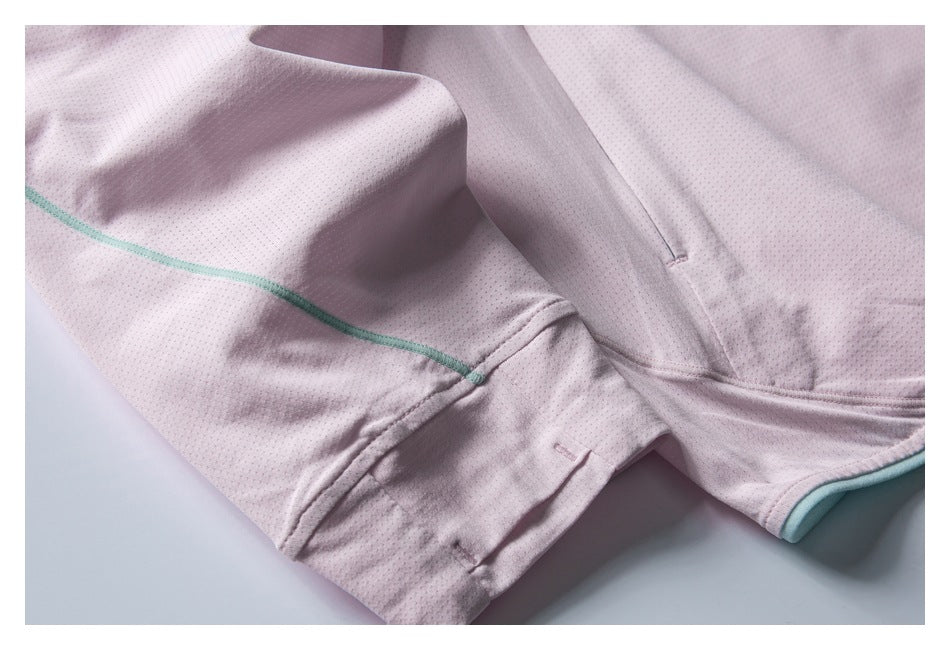 Close-up of the pale pink perforated jacket sleeve and cuff, showing mint piping and stitched seams.