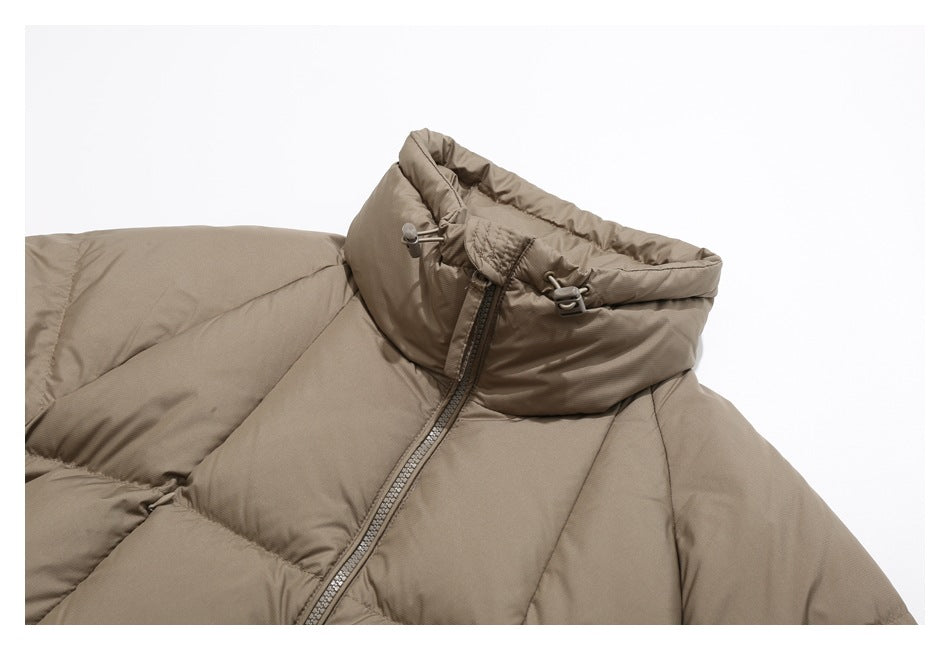 Close-up of a taupe puffer jacket’s high hooded collar, drawcord toggles and front zipper.
