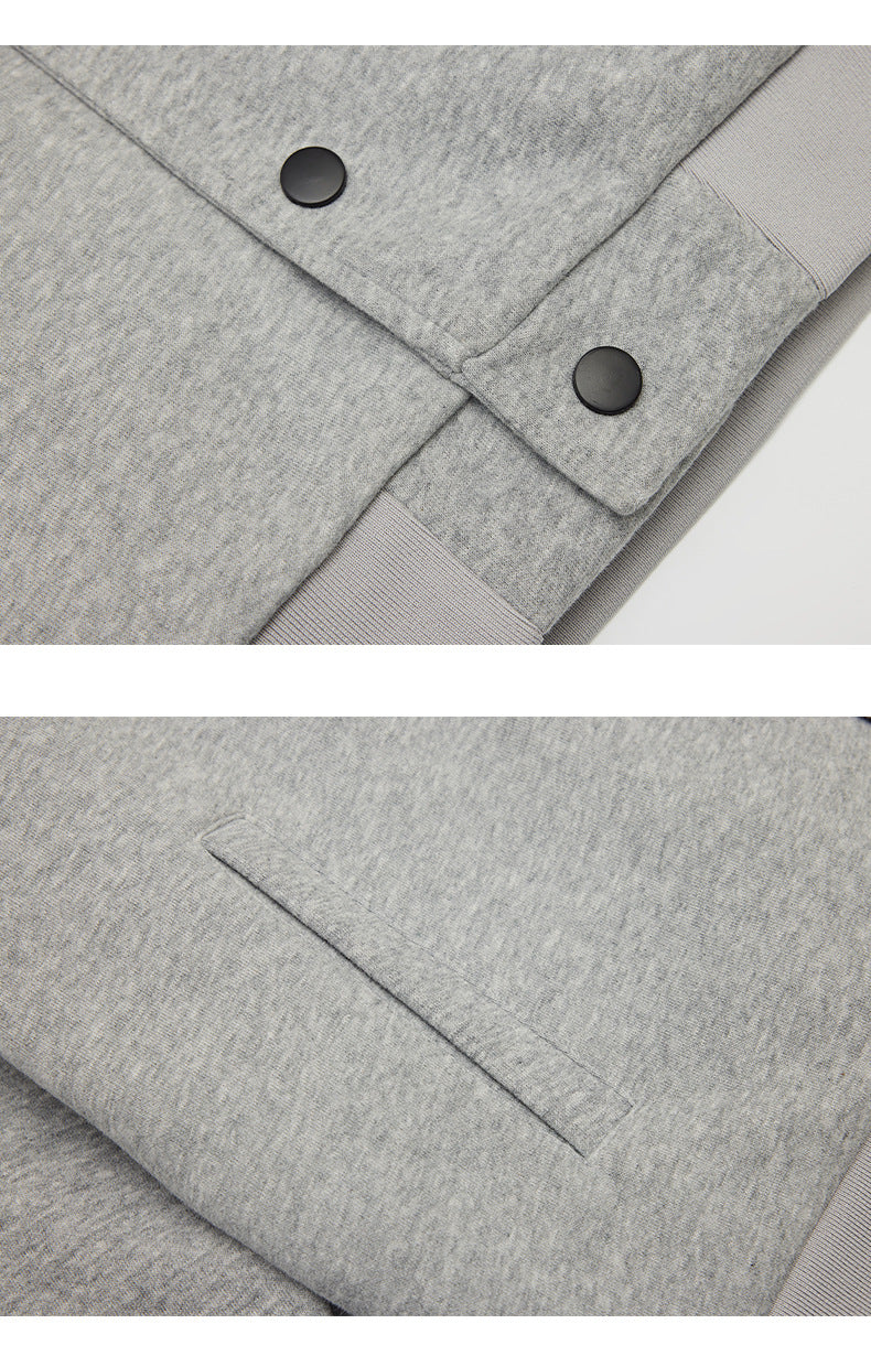 Close-ups of a heather gray jacket's black snap buttons and angled welt pocket.