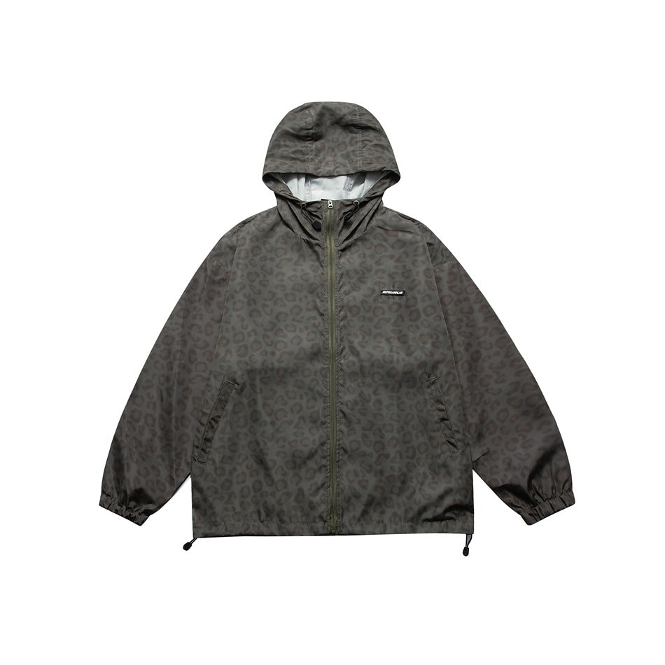 Olive-gray hooded zip jacket with tone-on-tone leopard print, front view with slant pockets and hem toggles