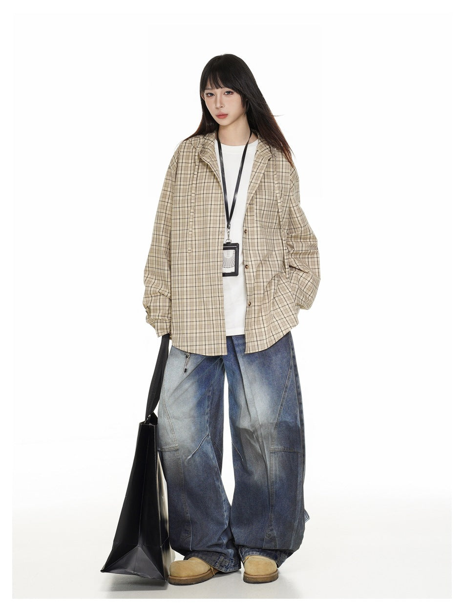 Model wearing khaki plaid hooded shirt open over a white tee with wide-leg jeans and a black tote bag