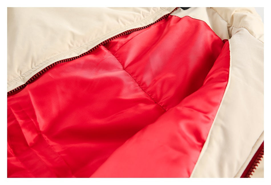 Beige garment opened to show bright red lining and a dark zipper.