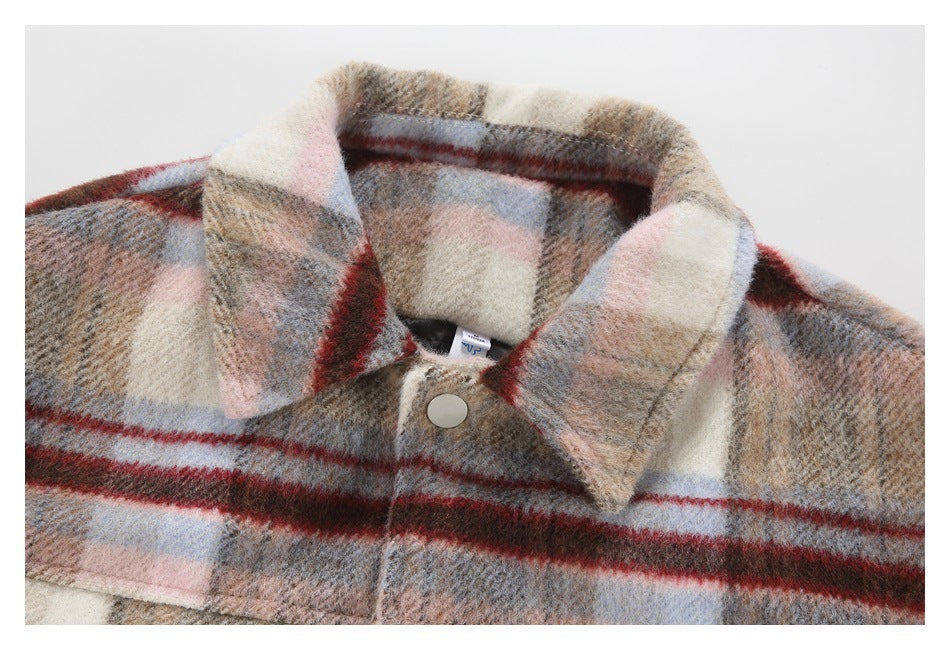 Close-up of a beige and gray plaid jacket collar, snap button, and inner neck label.