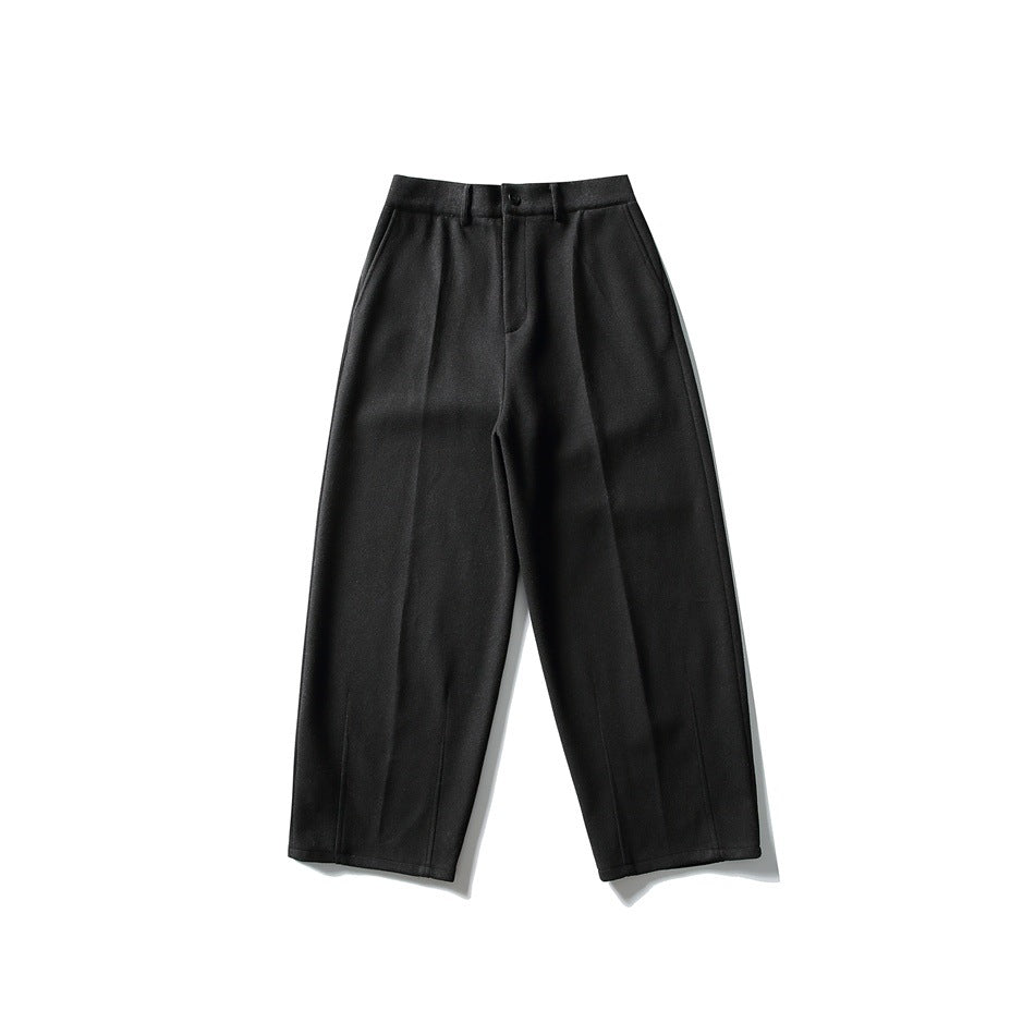Black wide-leg trousers flat lay, front view, with button fly, belt loops and front creases
