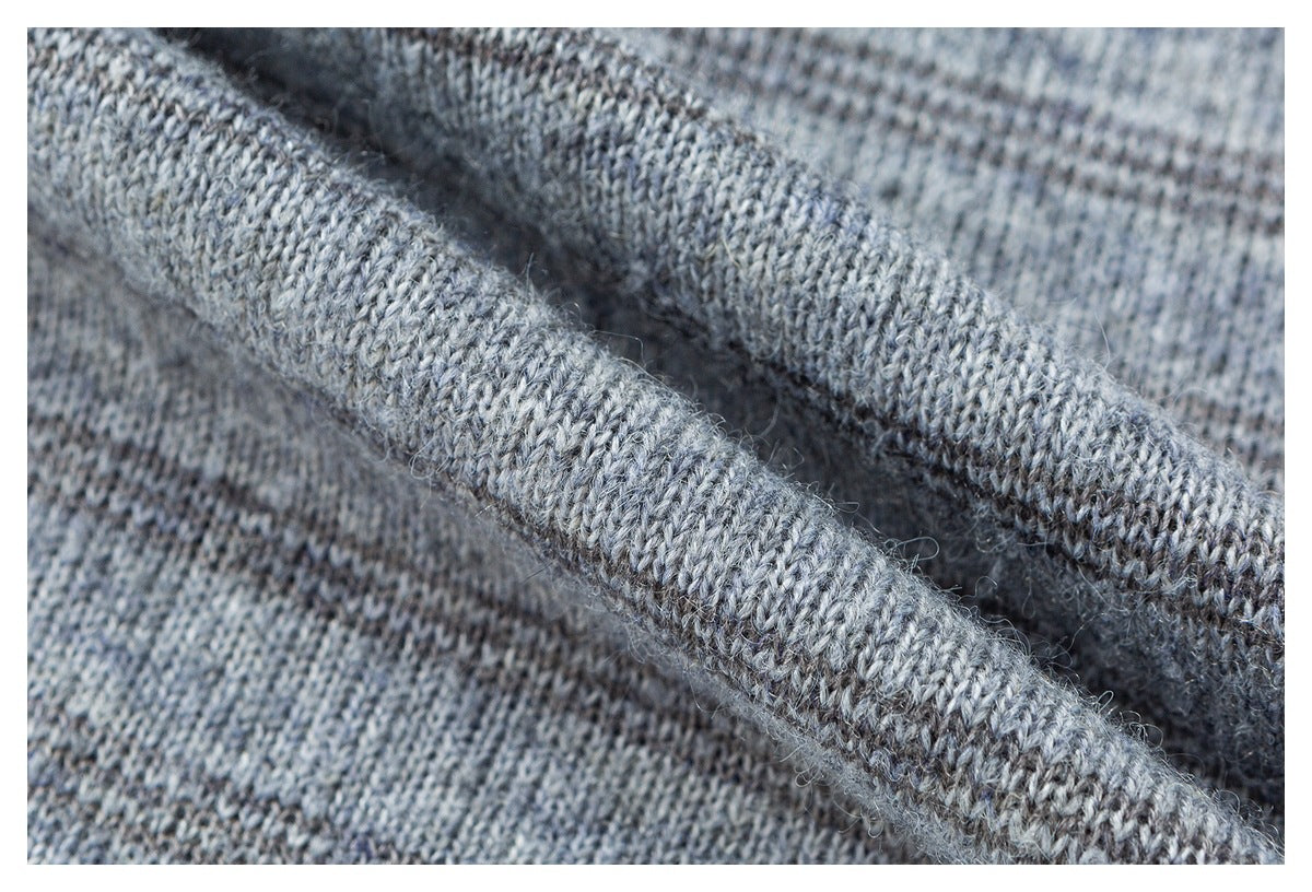 Close-up of heather gray knit fabric folded to show its textured stitching and edge.