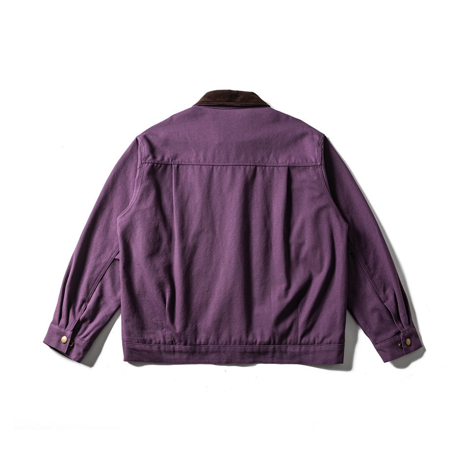 Back view of purple work jacket with yoke seam, banded hem and snap-button cuffs, flat lay