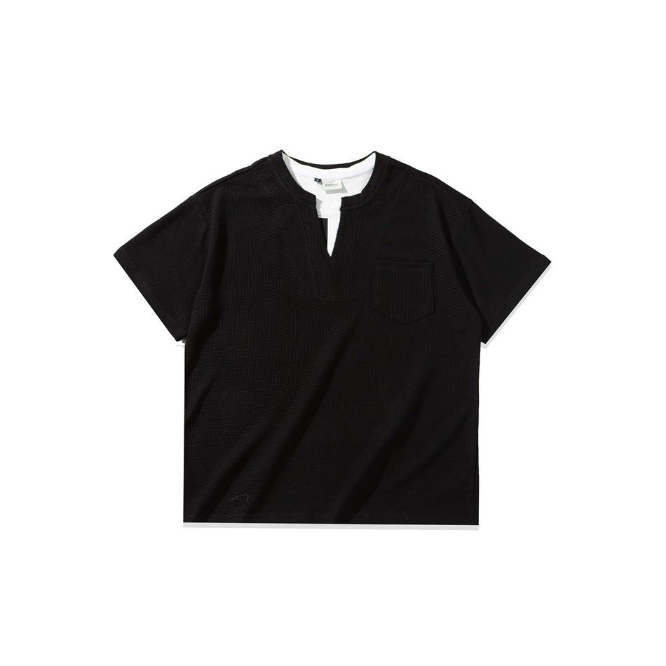 Black short-sleeve waffle-knit tee with notched V-neck, white inner layer and chest pocket, flat lay